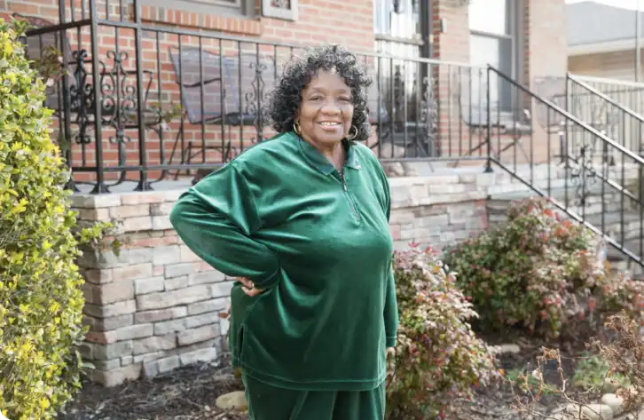 Deidra Cambers, a lady standing by a wall