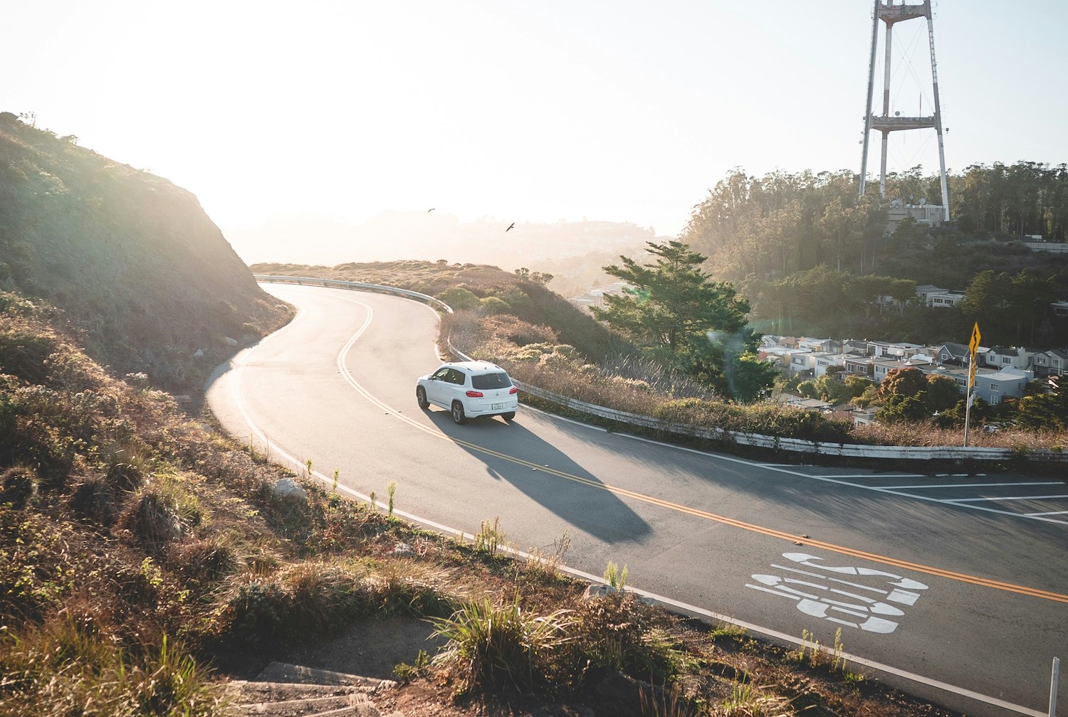 Image of an electric vehicle driving around a curve.